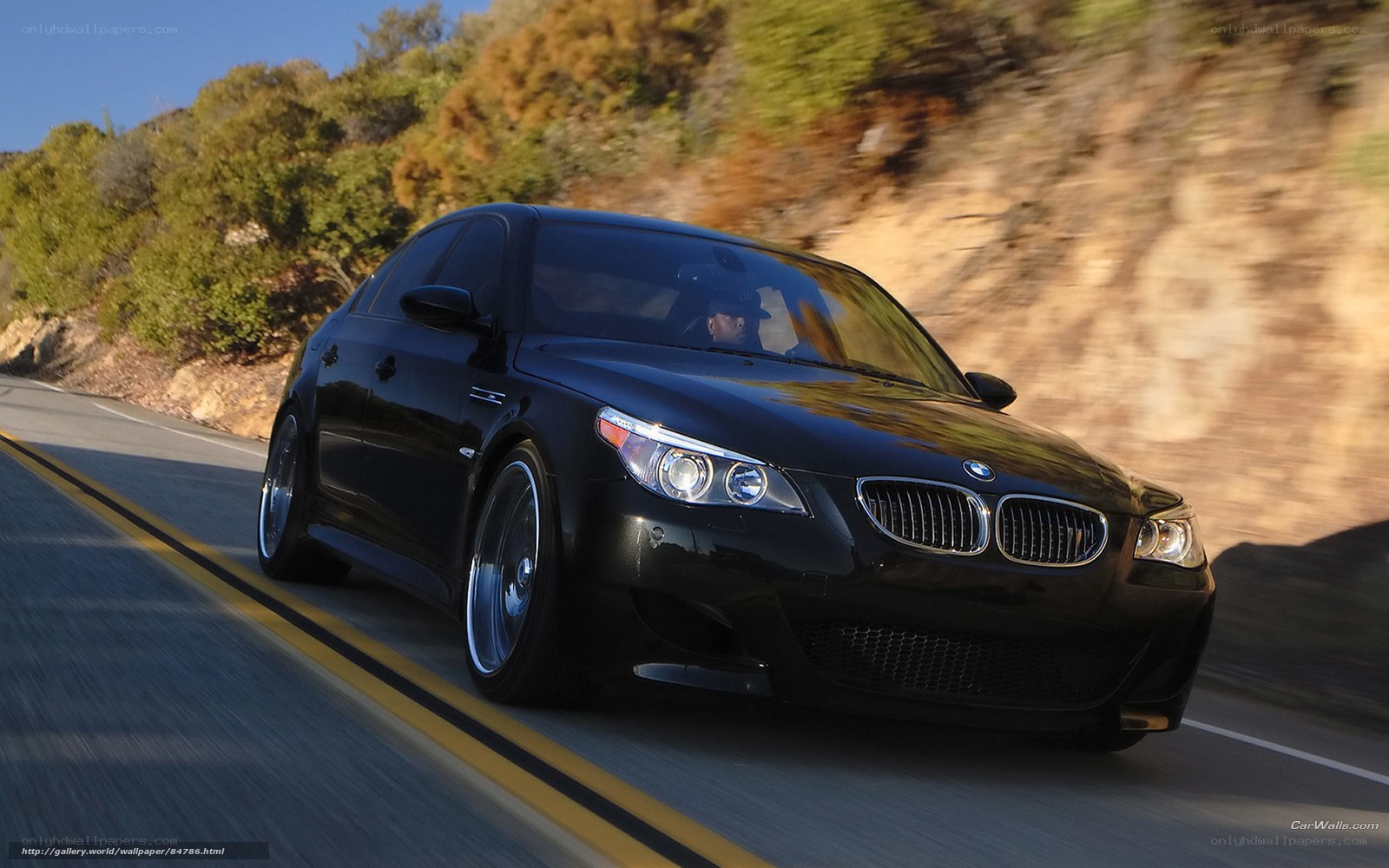 black bmw m5 driving on road