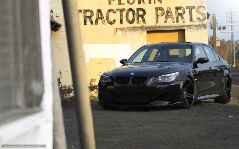 Black BMW M5 in front of a building