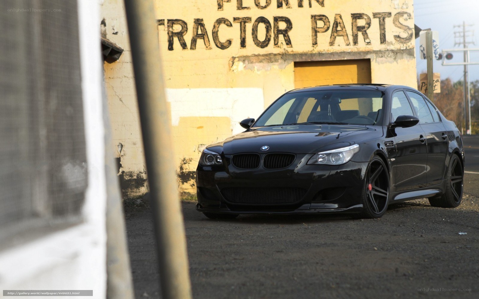 Black BMW M5 in front of a building