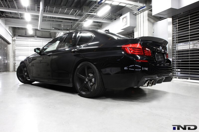 Black BMW M5 in garage