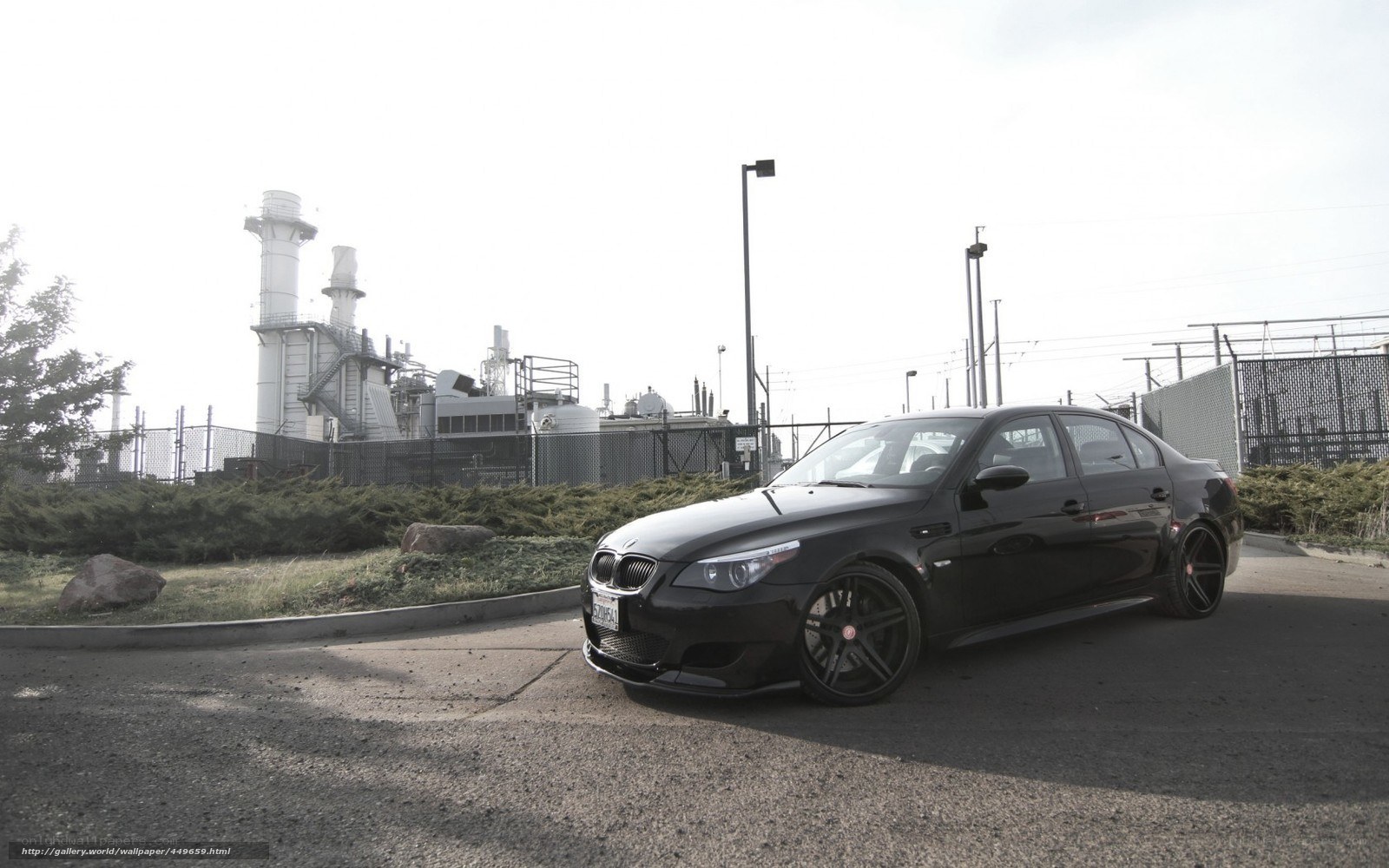Black BMW M5 in industrial area