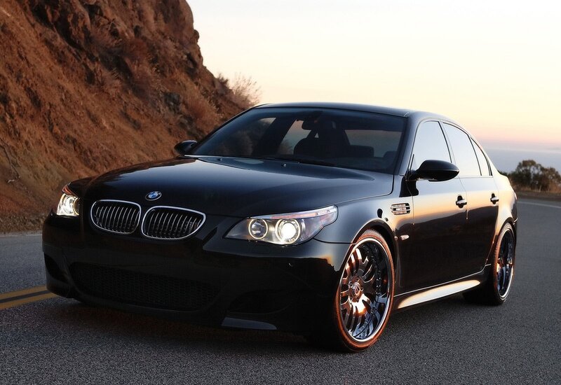 Black BMW M5 on a coastal road