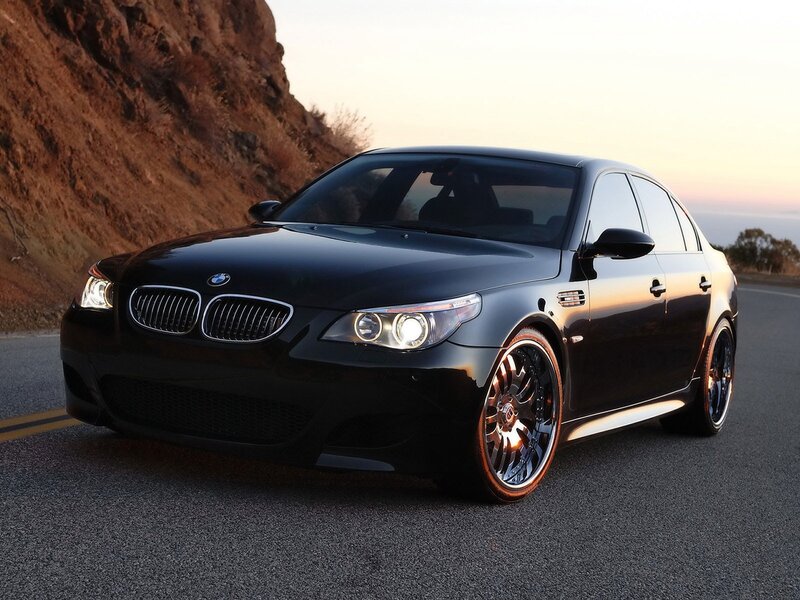Black BMW M5 on a coastal road