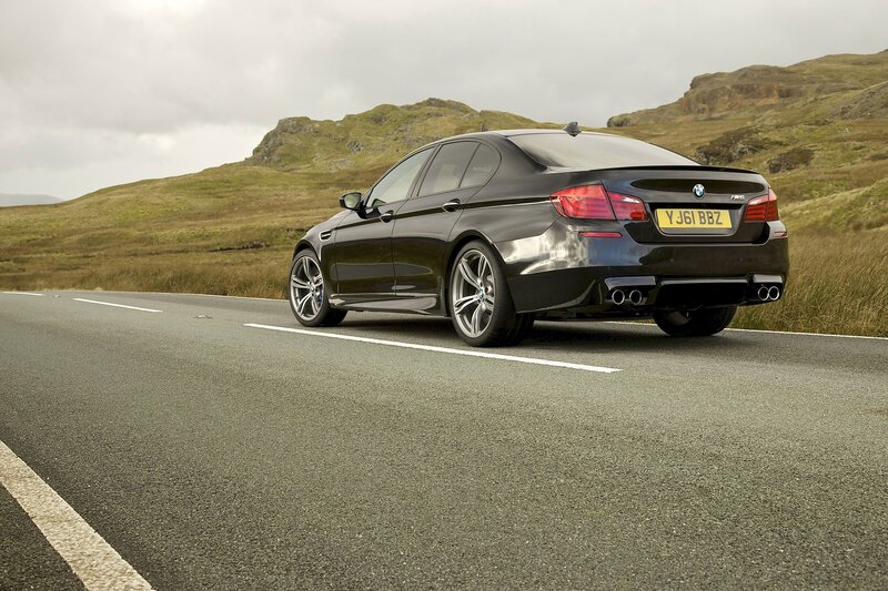 Black BMW M5 on a country road