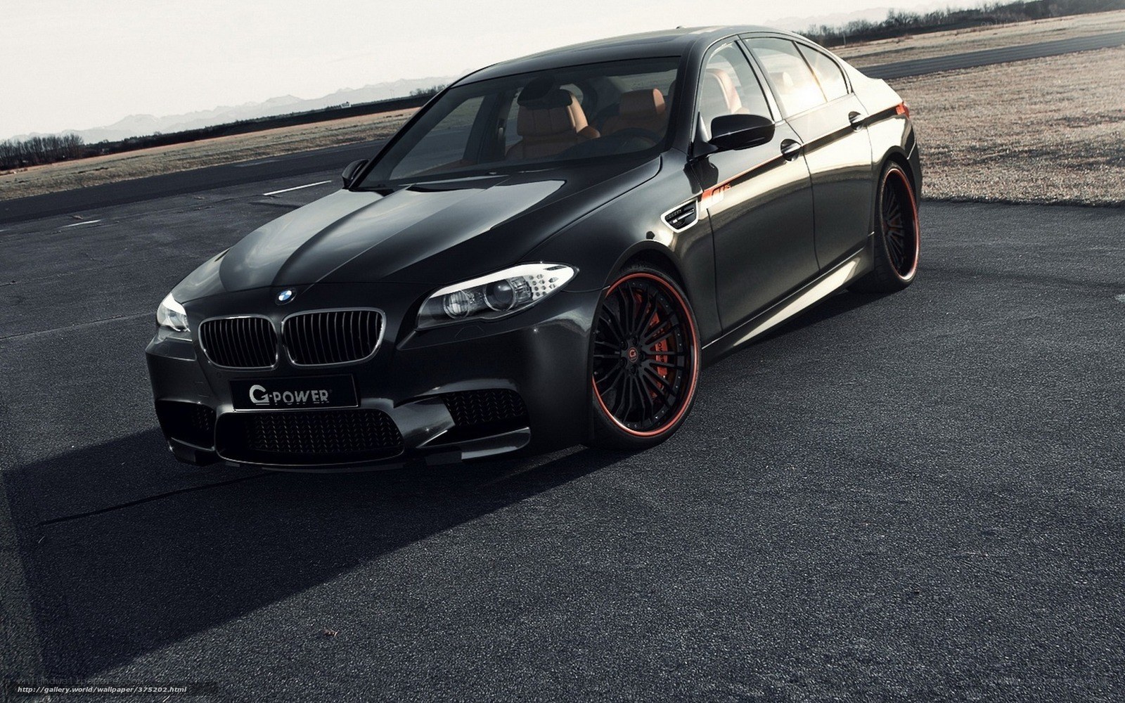 Black BMW M5 on a runway
