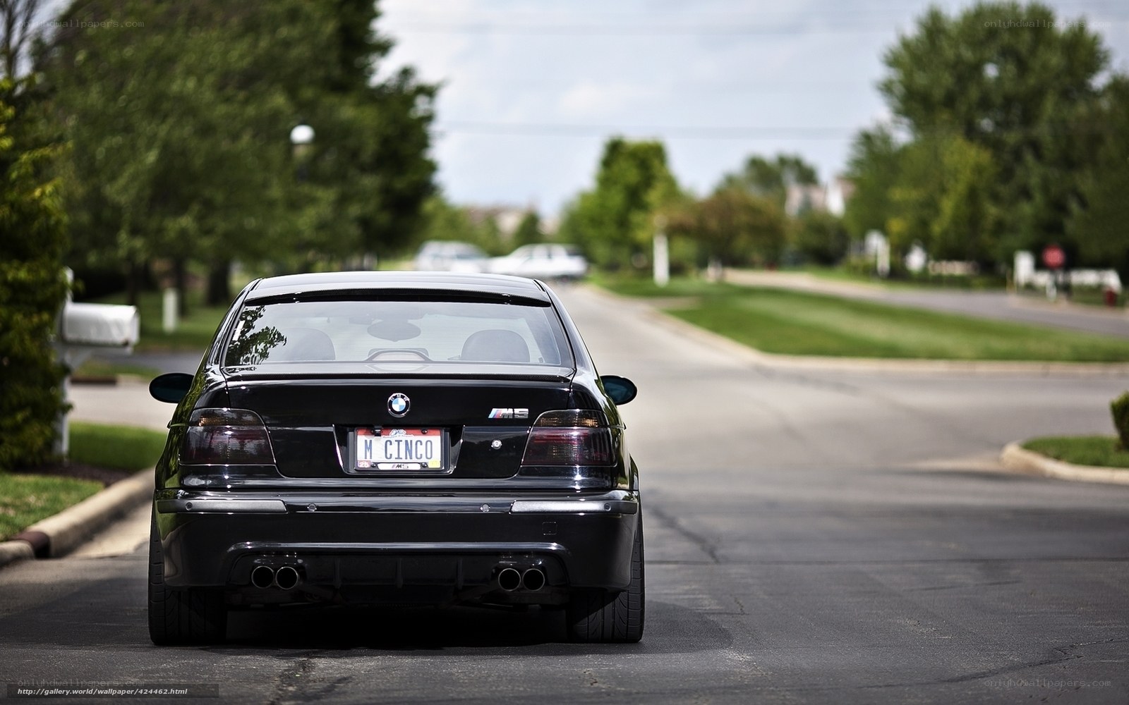 Black BMW M5 on a suburban street