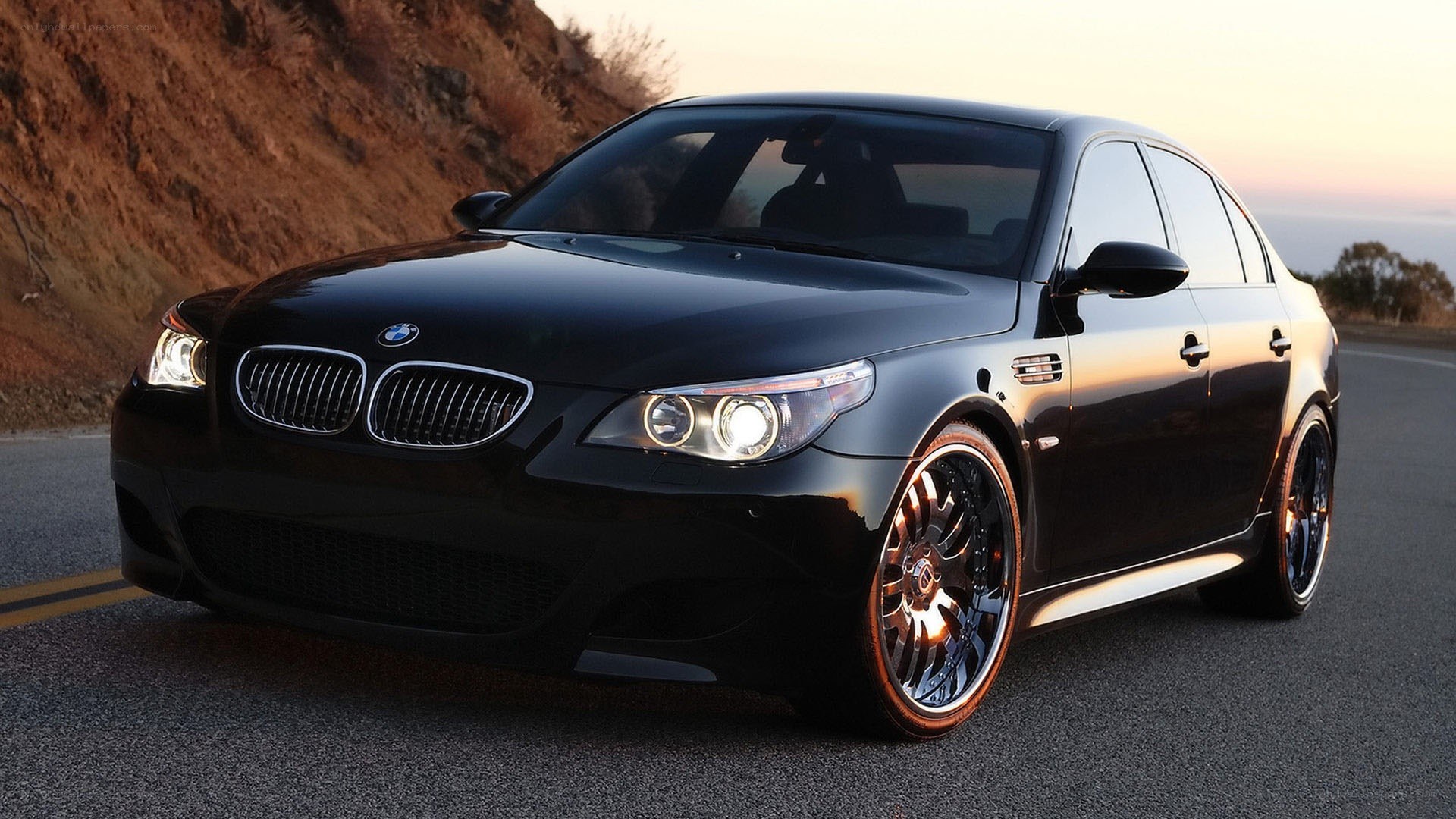 black bmw m5 on road