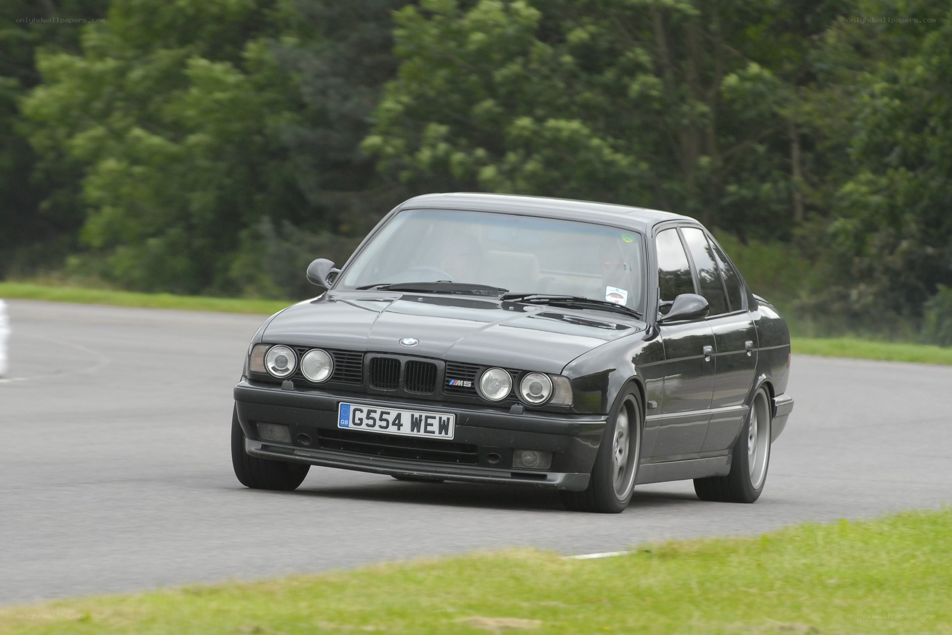 black bmw m5 on track