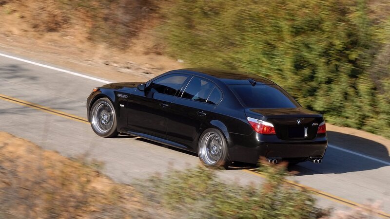 black bmw m5 on winding road