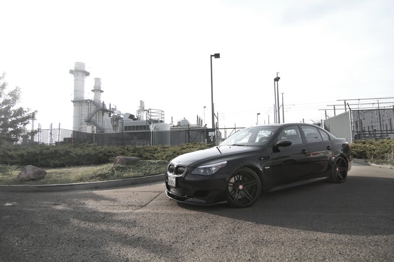Black BMW M5 parked near factory