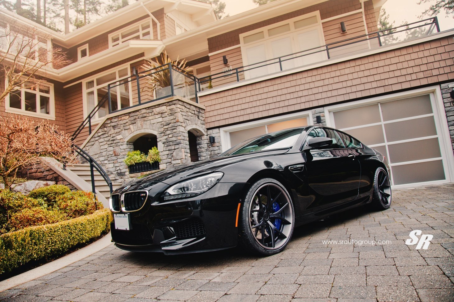 Black BMW M6 in driveway