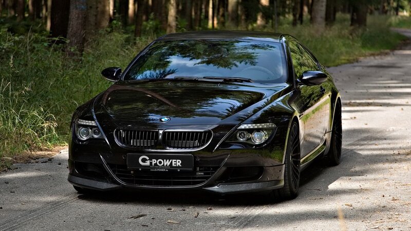 Black BMW M6 on forest road