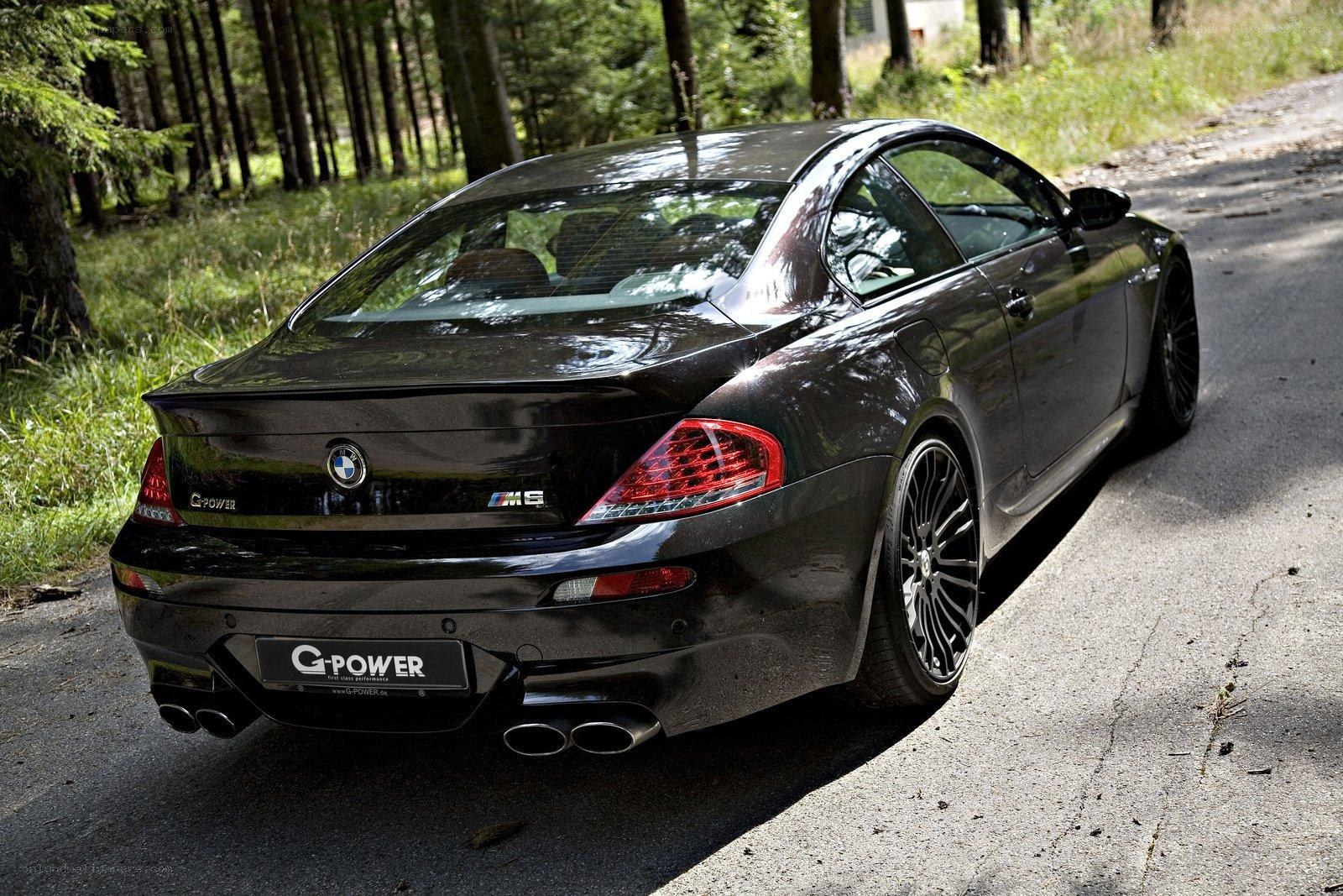 Black BMW M6 on forest road