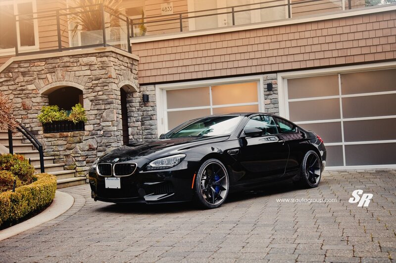 Black BMW M6 parked in driveway