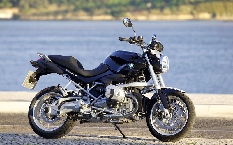 Black BMW motorcycle by the water
