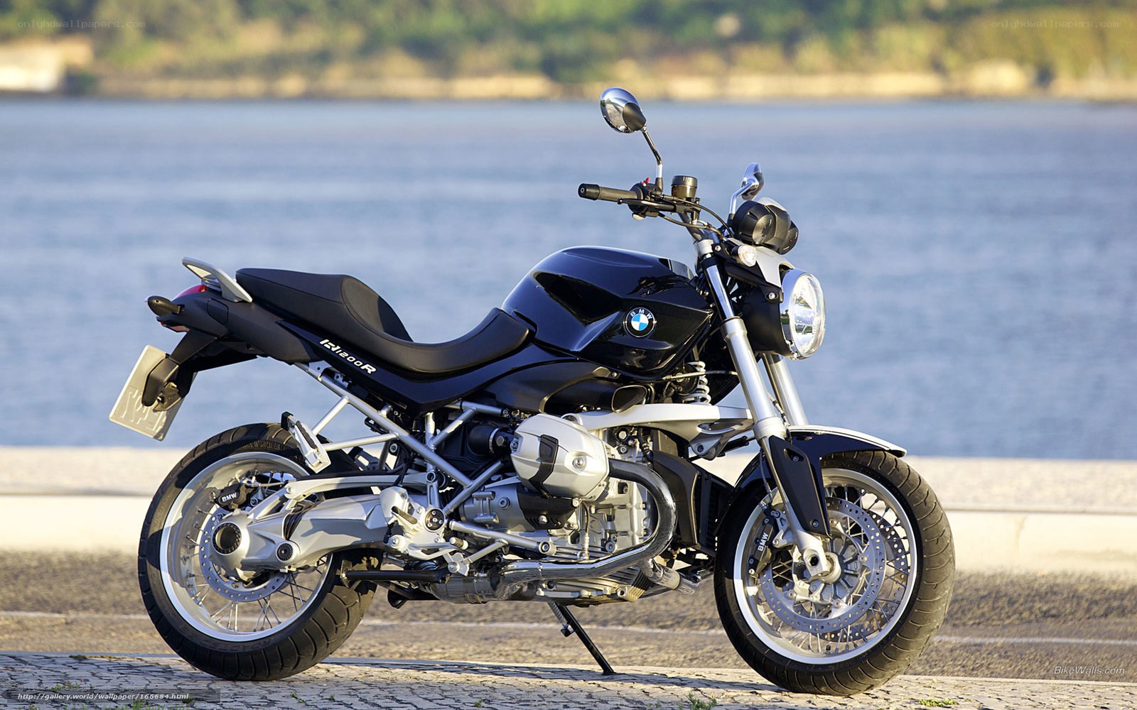 Black BMW motorcycle by the water