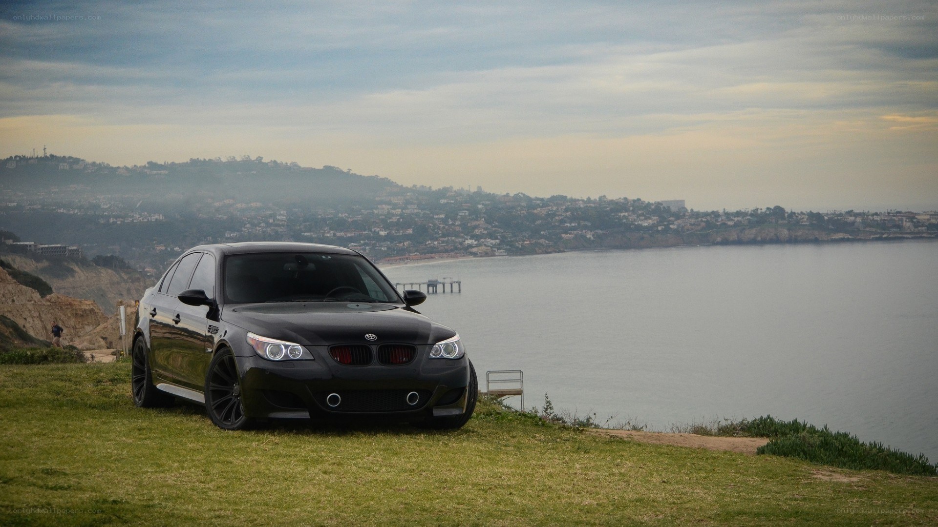 Black BMW on a coastal cliff