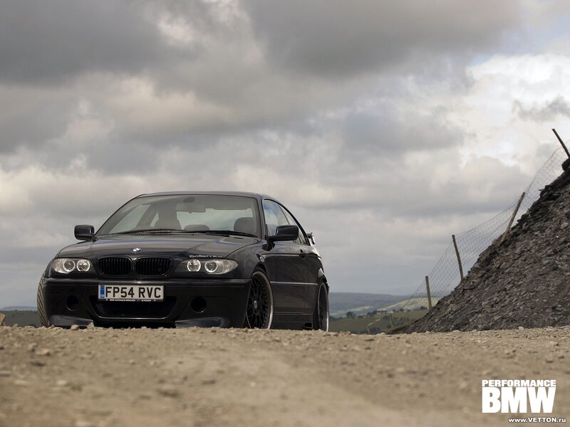 Black BMW on a gravel road