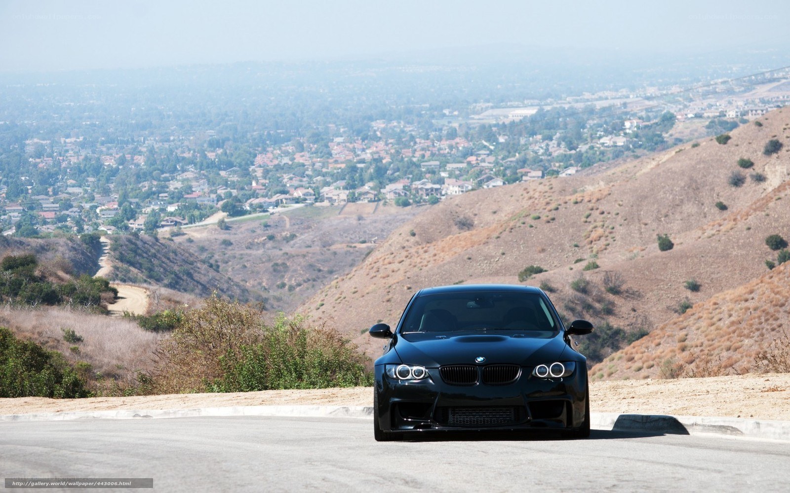 Black BMW on a hillside road