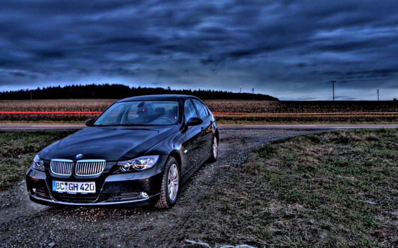 Black BMW on a rural road