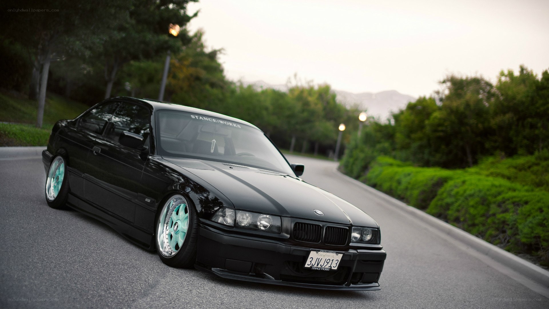 black bmw on a winding road
