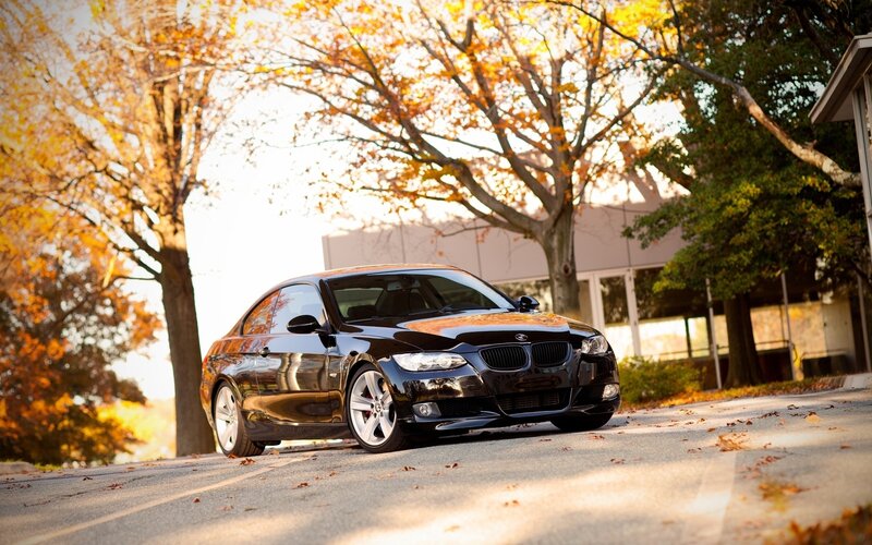 Black BMW on autumn street