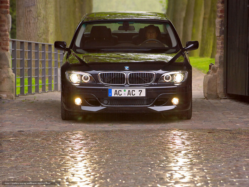 Black BMW on cobblestone path