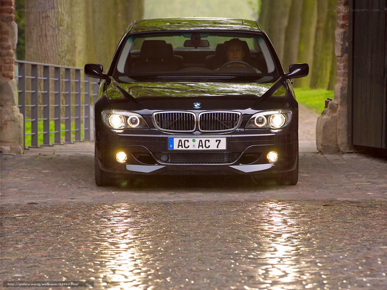 Black BMW on cobblestone path