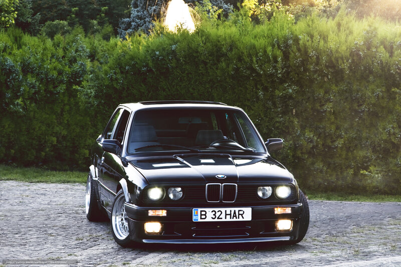 Black BMW on cobblestone