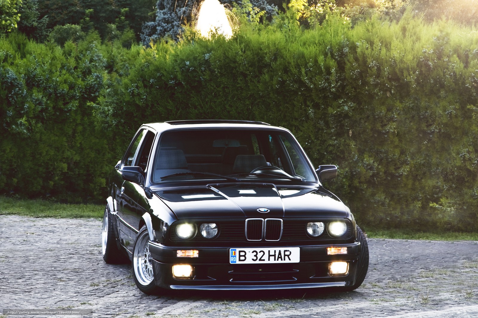 Black BMW on cobblestone