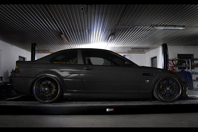 black bmw on lift in garage