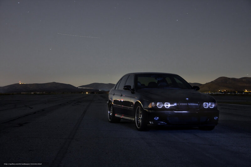 Black BMW on runway at night