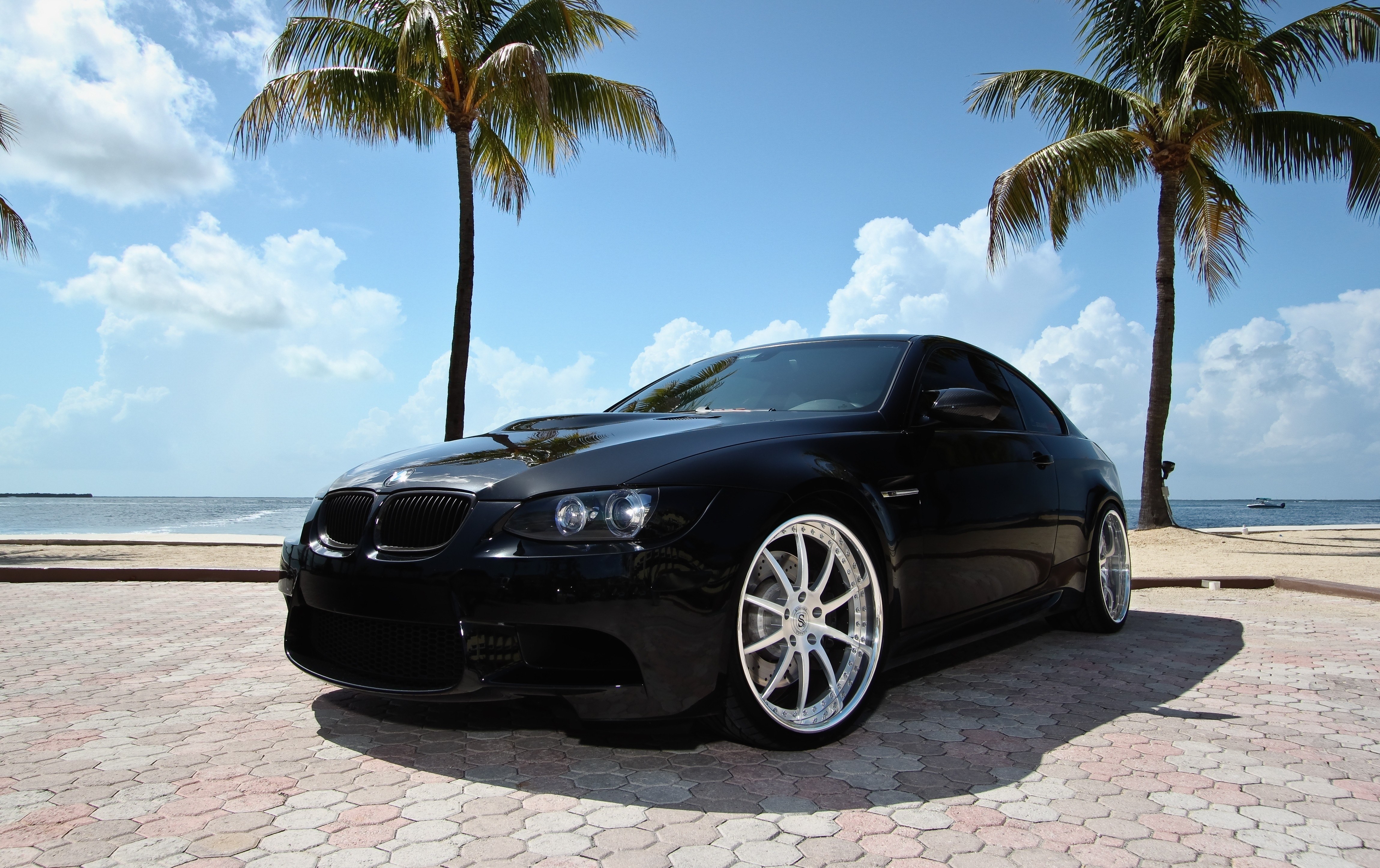 Black BMW on tropical beach