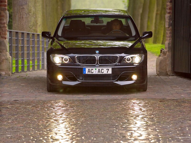 black bmw on wet cobblestones