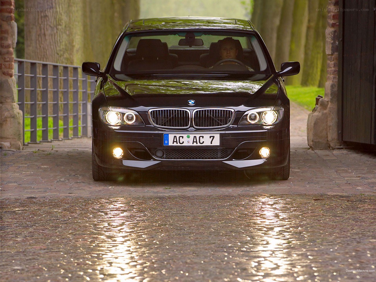 black bmw on wet cobblestones
