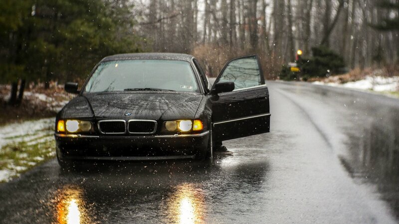 Black BMW on Wet Road — Dreary
