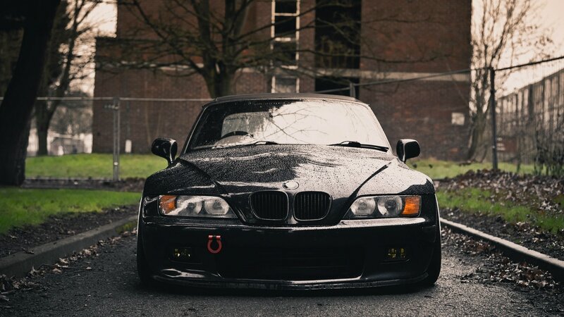black bmw on wet road