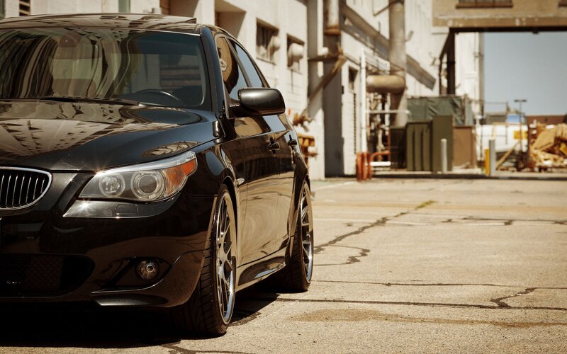 black bmw parked in industrial lot