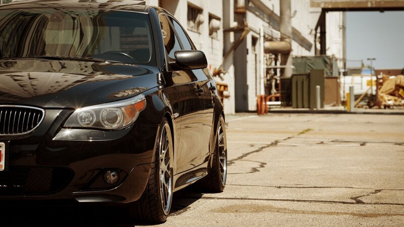 black bmw parked in industrial lot