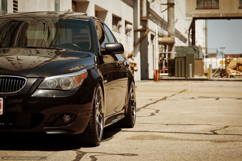 Black BMW parked in industrial lot