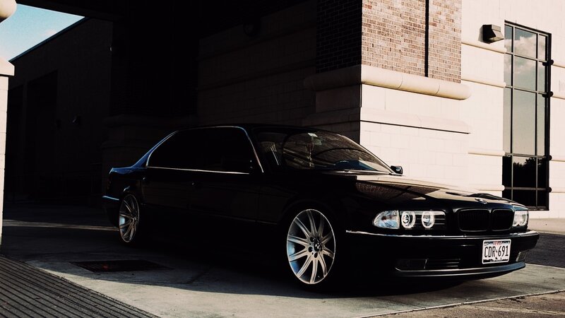 black bmw parked in shadow