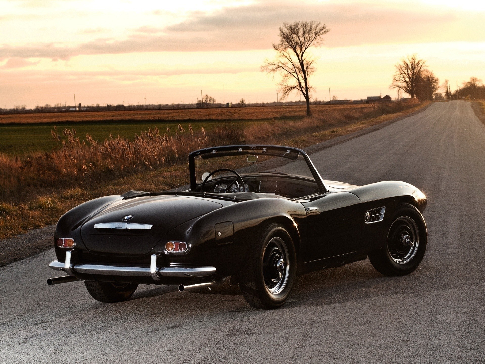 Black BMW roadster at sunset