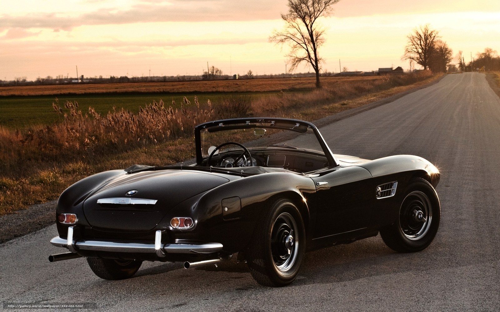 Black BMW roadster at sunset