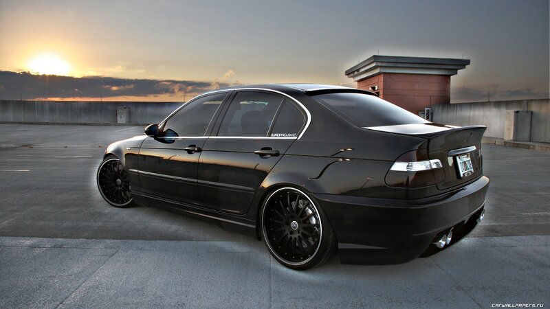 black bmw sedan at sunset