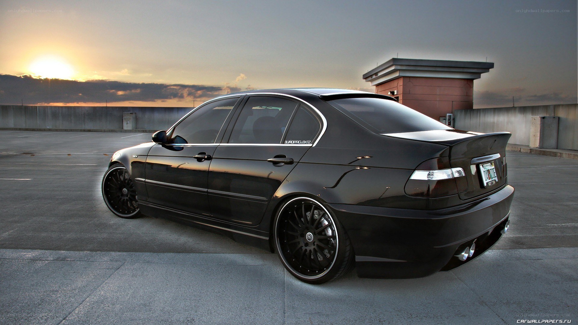 black bmw sedan at sunset