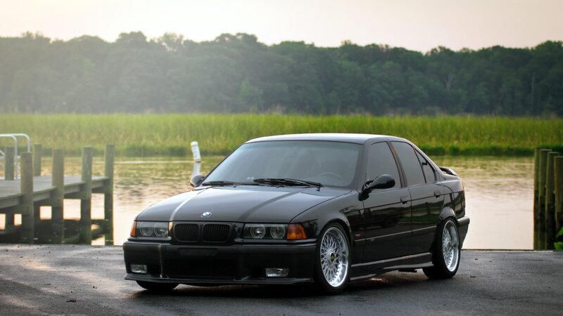 black bmw sedan by the water