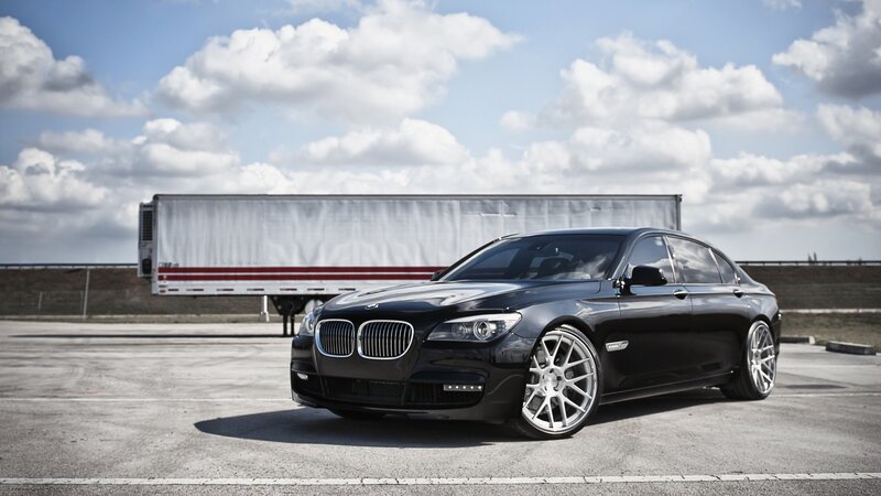 Black BMW Sedan — Dramatic, Afternoon, Photograph, Truck Trailer, Clouds, Pavement