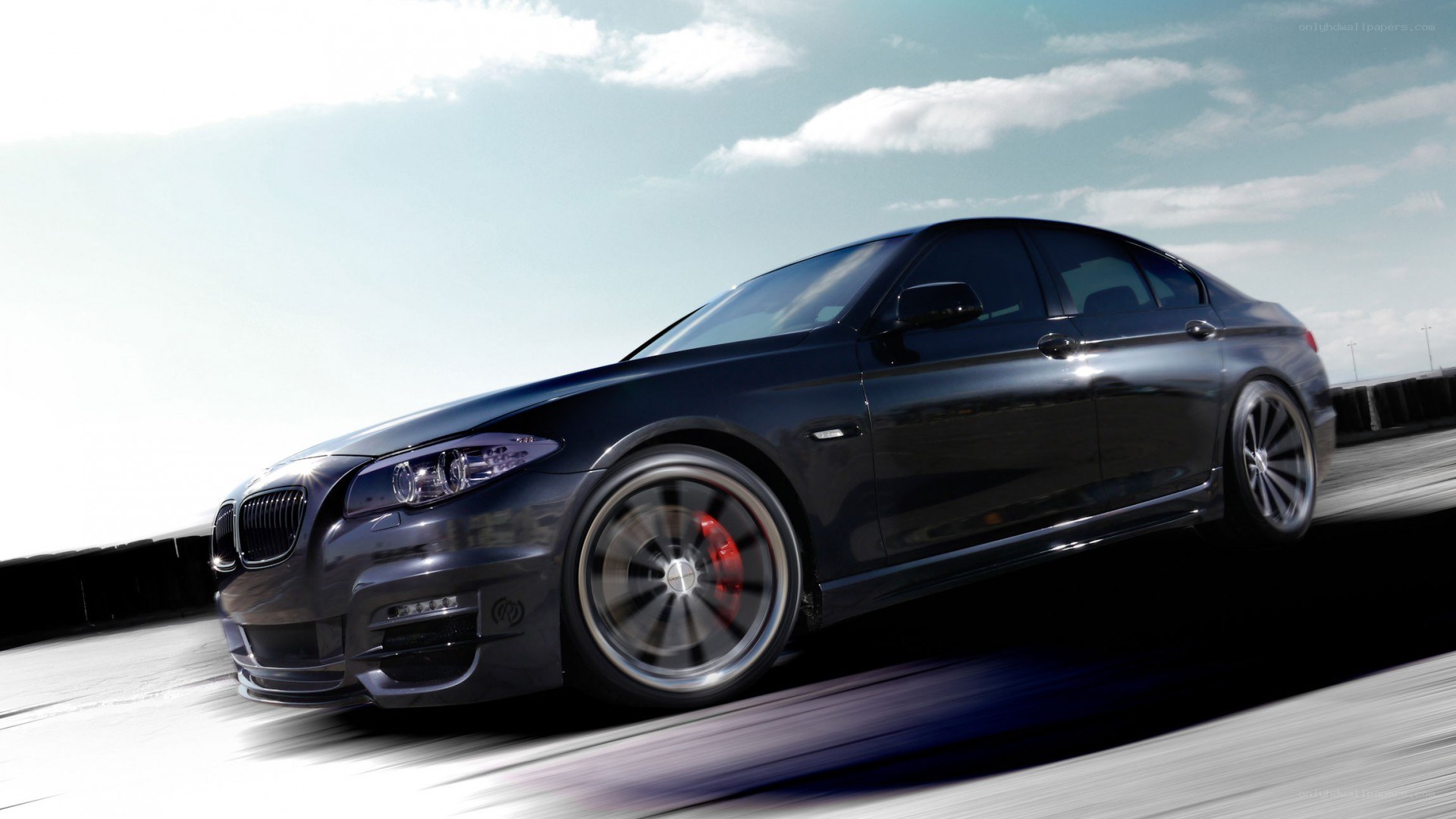 black bmw sedan in motion