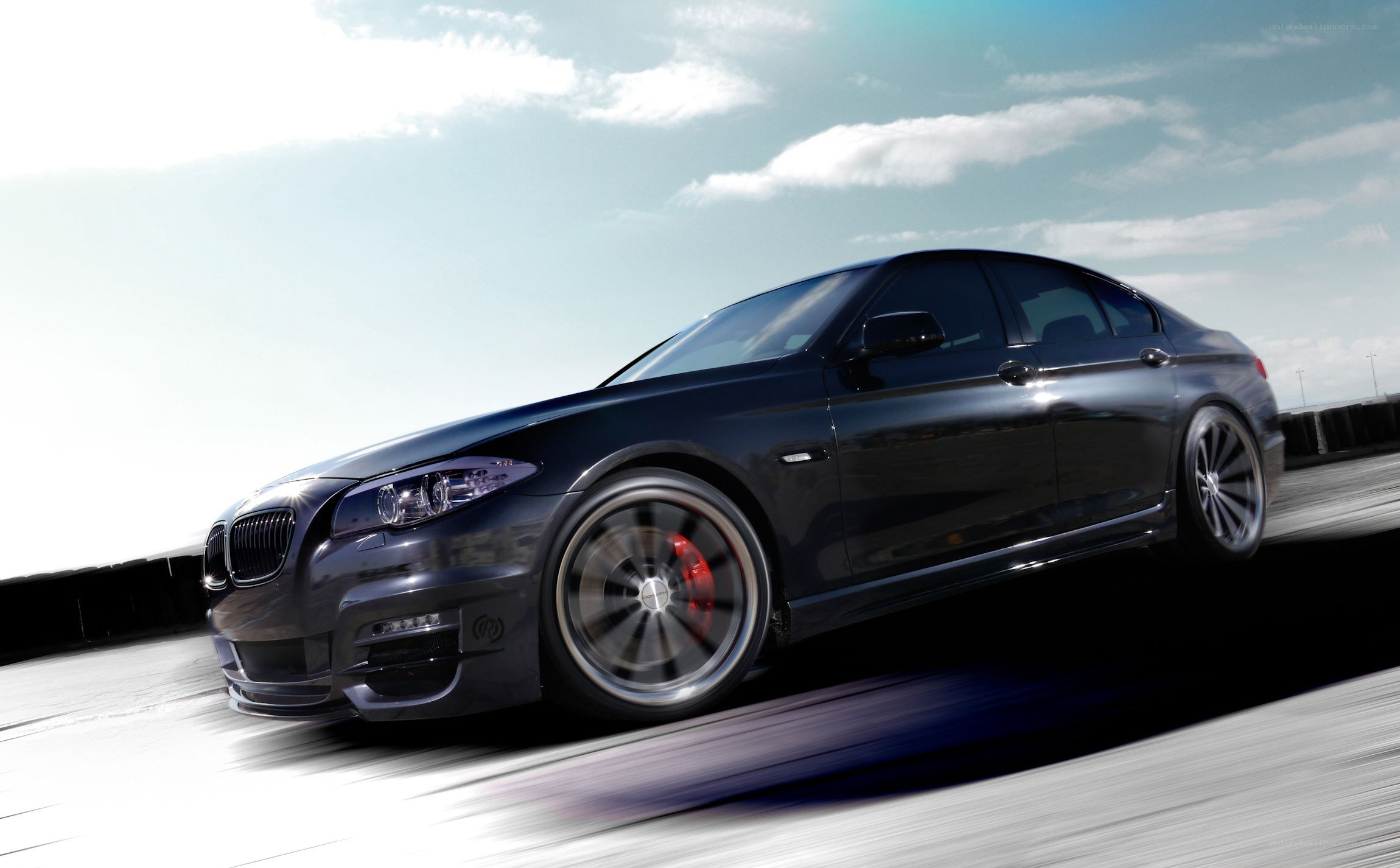 black bmw sedan in motion