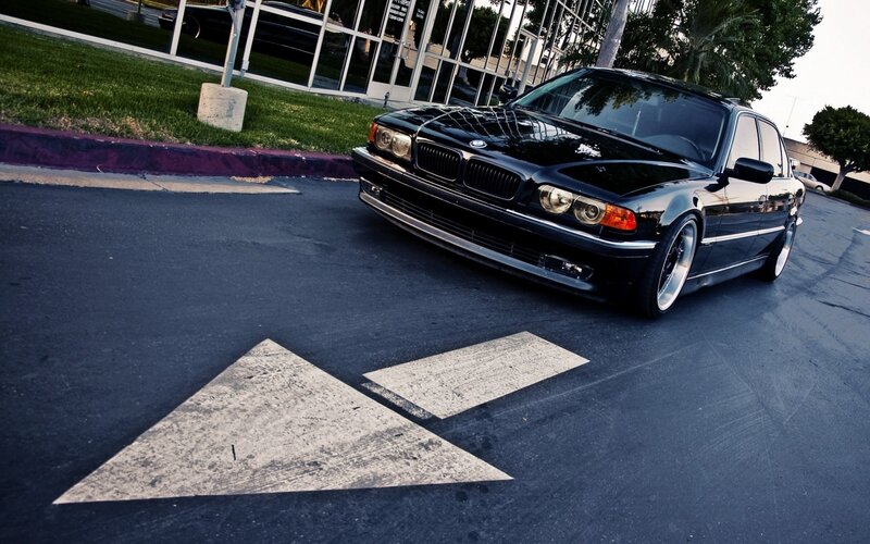 black bmw sedan in parking lot